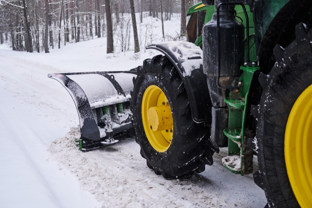 Snow removal tractor on forest road